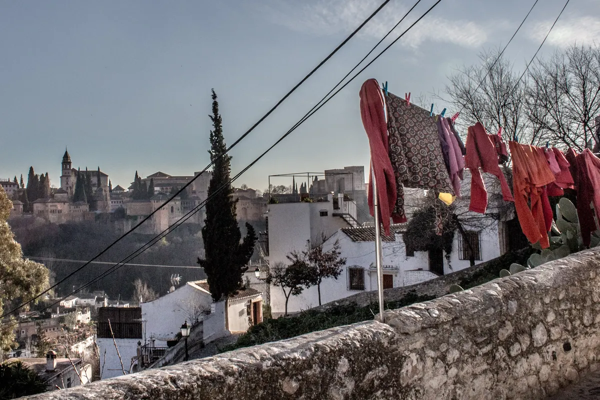 A washing line on a Sacromonte wall with the Alhambra on the hill beyond